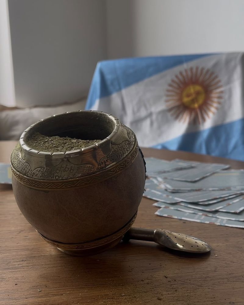 Mate galleta sobre una mesa con una bandera argentina de fondo